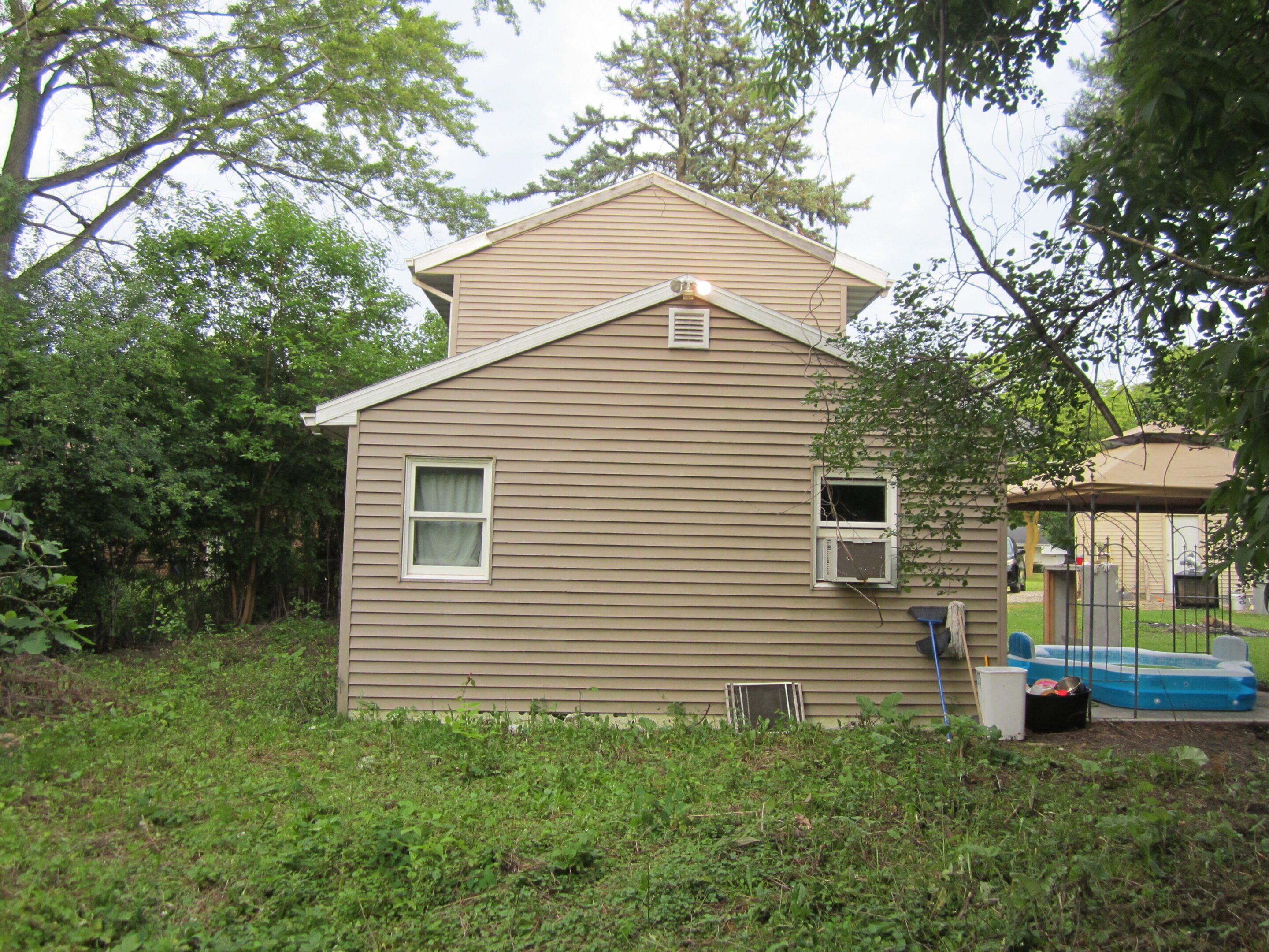 Backyard view of beige house